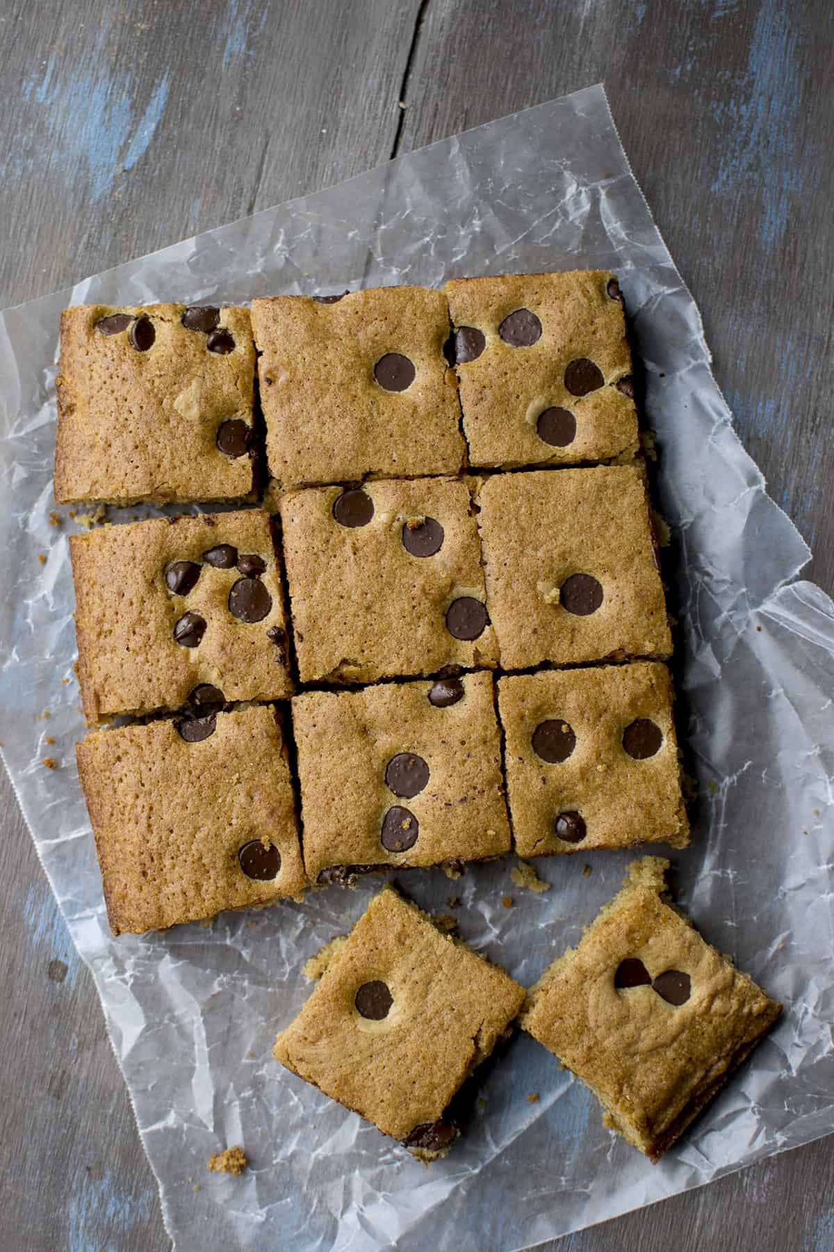 Parchment paper with chocolate chip topped blondies