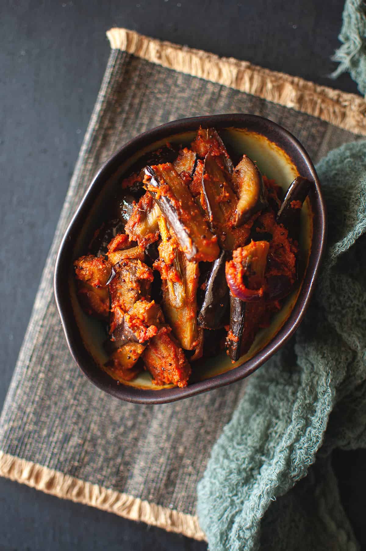 Black bowl with Sri Lankan eggplant pickle.