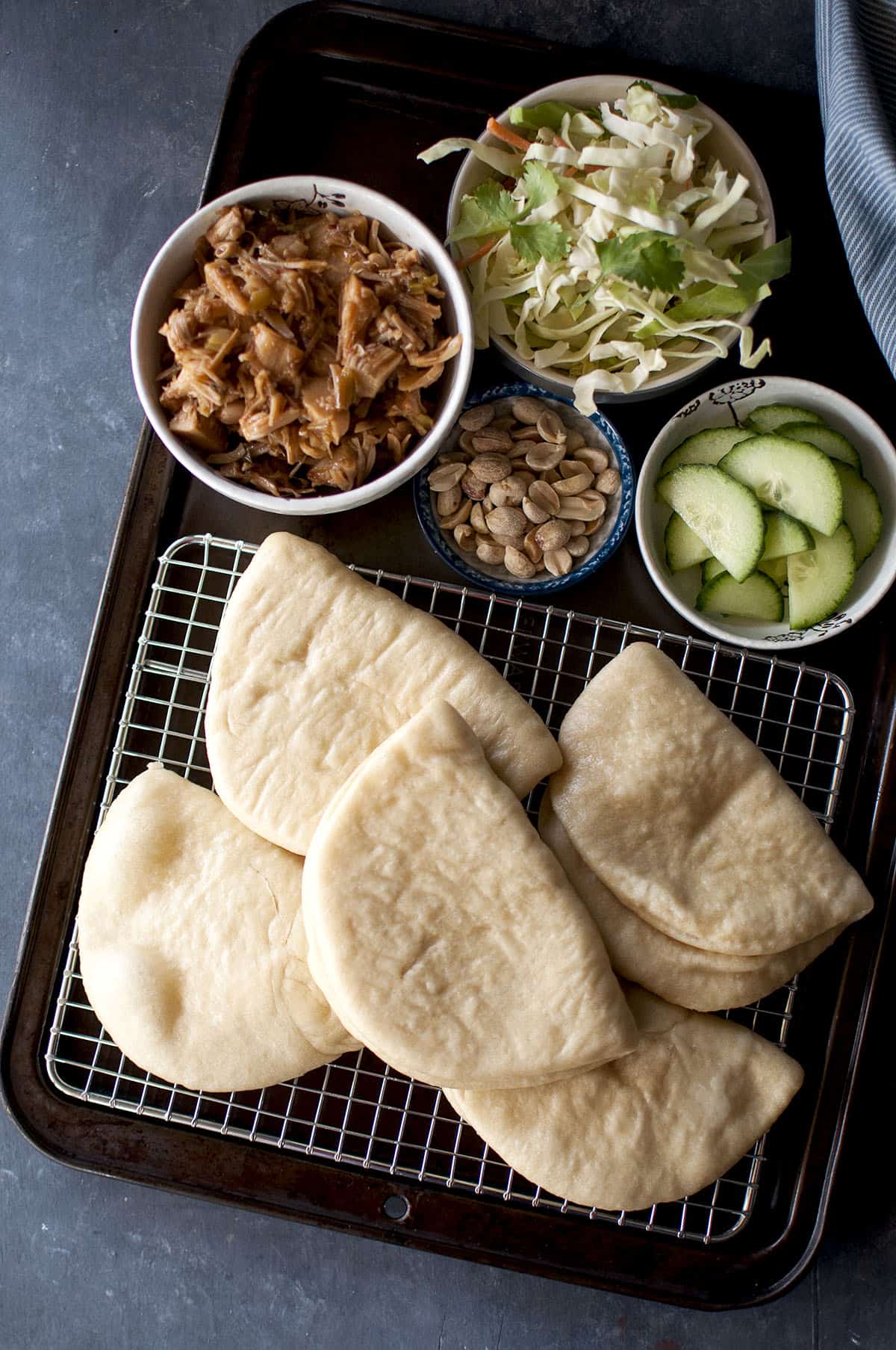 Baking tray with a steamed buns and the toppings and fillings