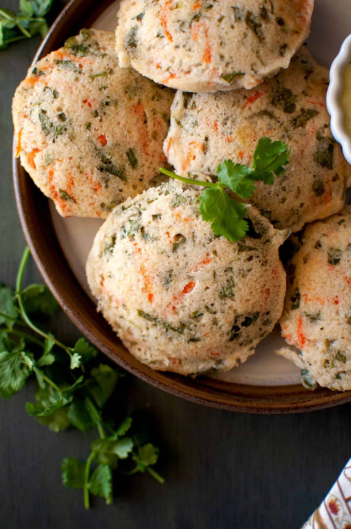 Brown plate with mix vegetable idli.