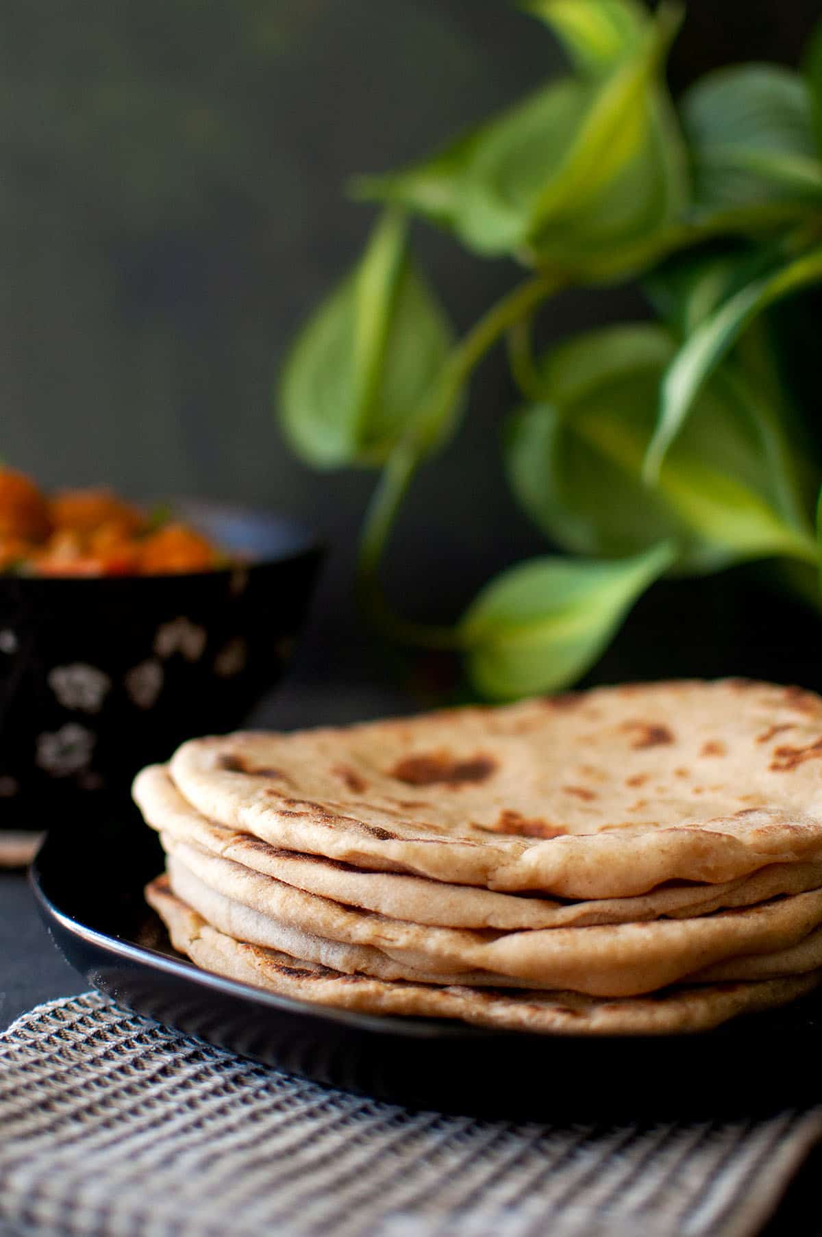 Black plate with a stack of yogurt naan.