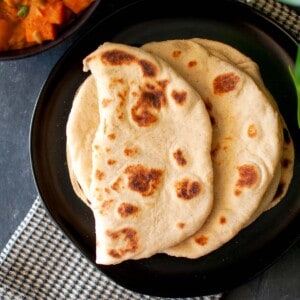 Black plate with soft flatbread.