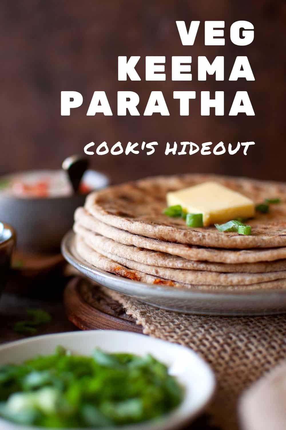 Grey plate with a stack of veg kheema paratha