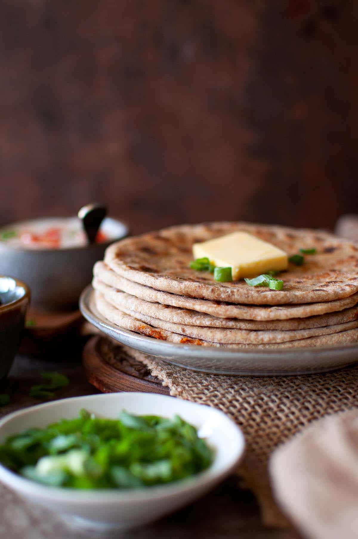 Grey plate with a stack of veg kheema paratha