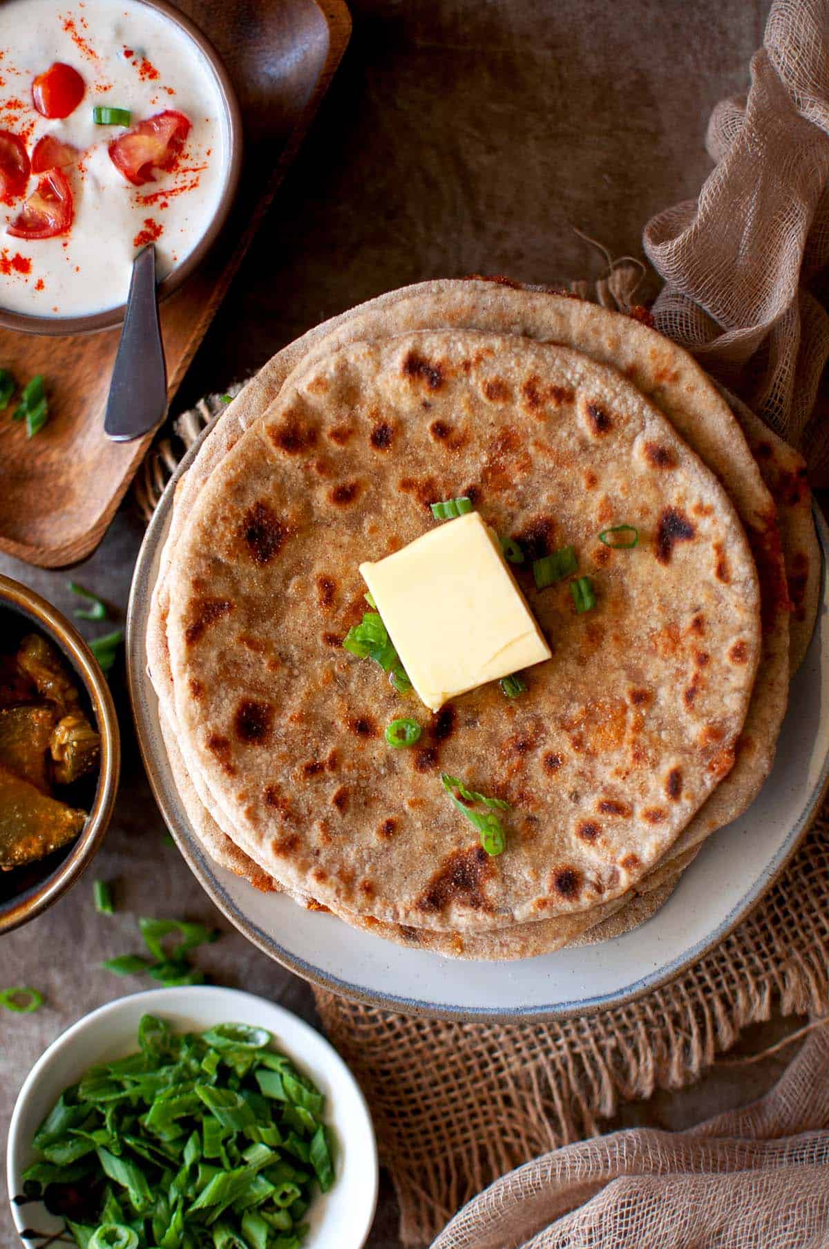 Top view of stack of Indian flatbread with a pat of butter