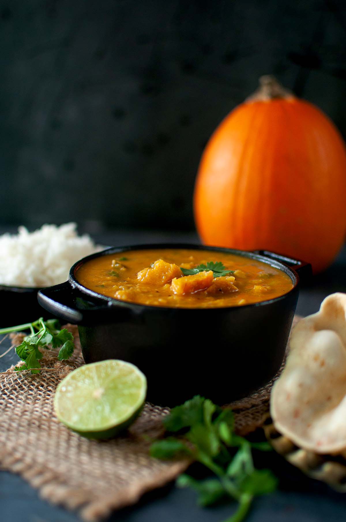 Black pan with roasted pumpkin sambar