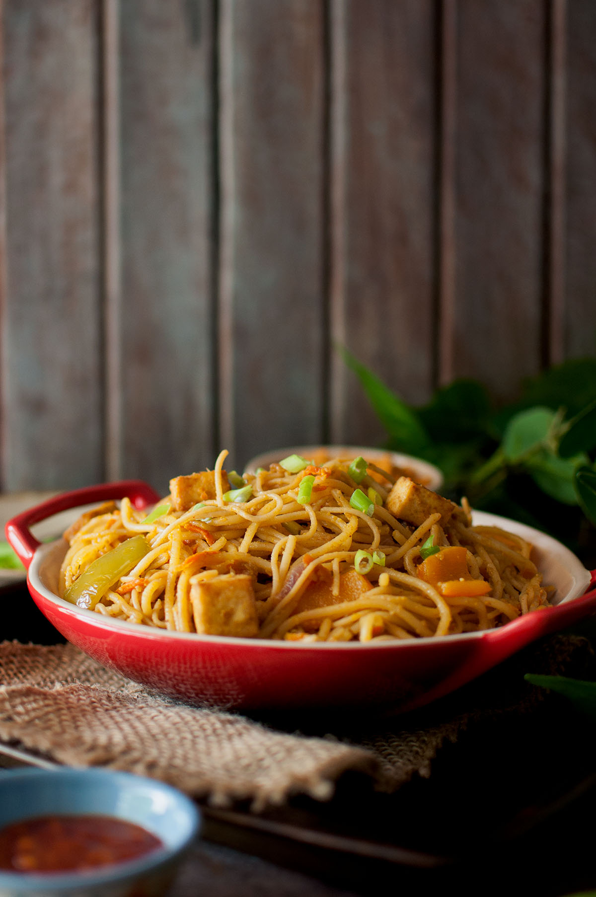 Red bowl with peanut noodles.