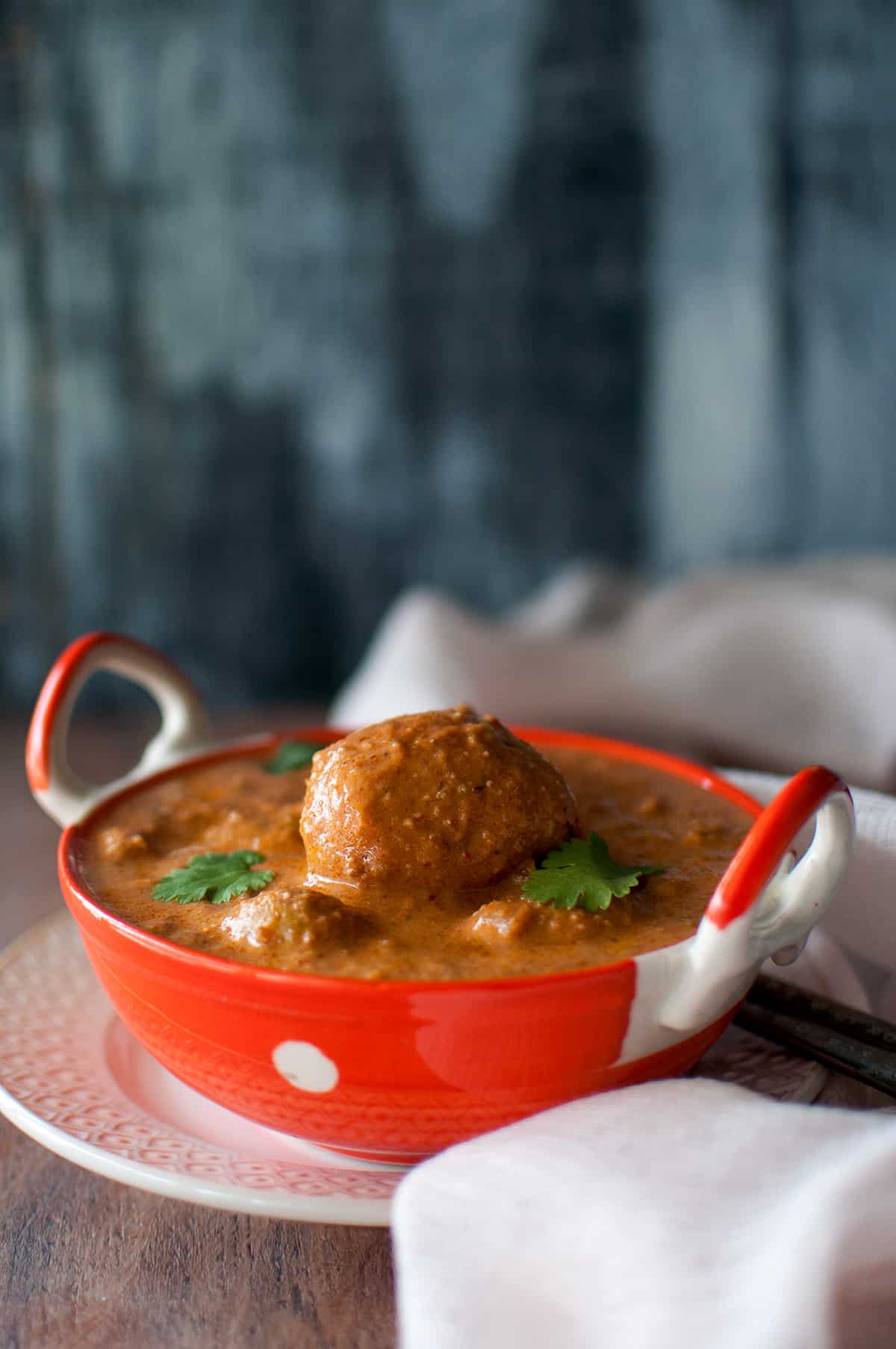 Orange bowl with baby aloo curry.