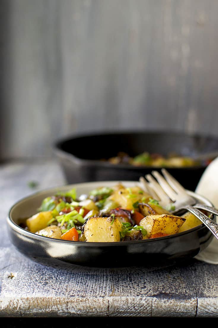 Black plate with Italian style vegetable side dish