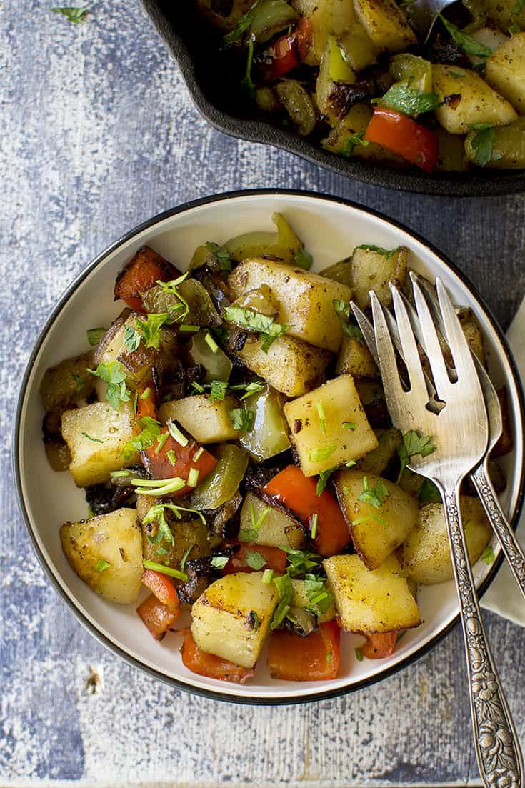 White plate with Italian fried potatoes with peppers