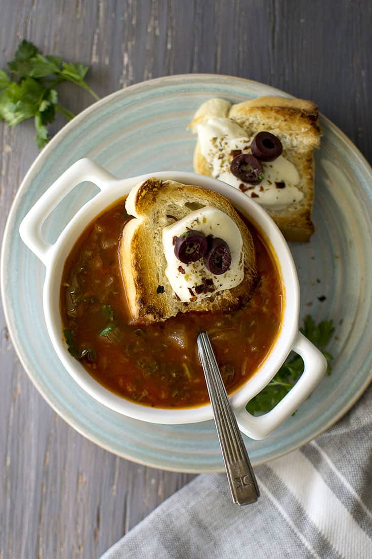 Bowl of vegetarian tomato soup with cheesy crouton on top