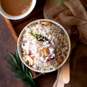 Top view of a white bowl with rice vermicelli topped with coconut.