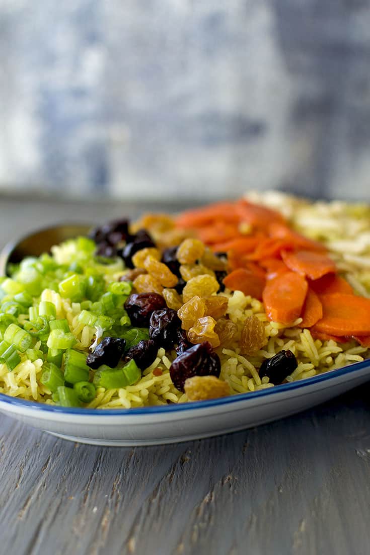 Plate of Holiday Jeweled Rice with dry fruit, scallions and carrots