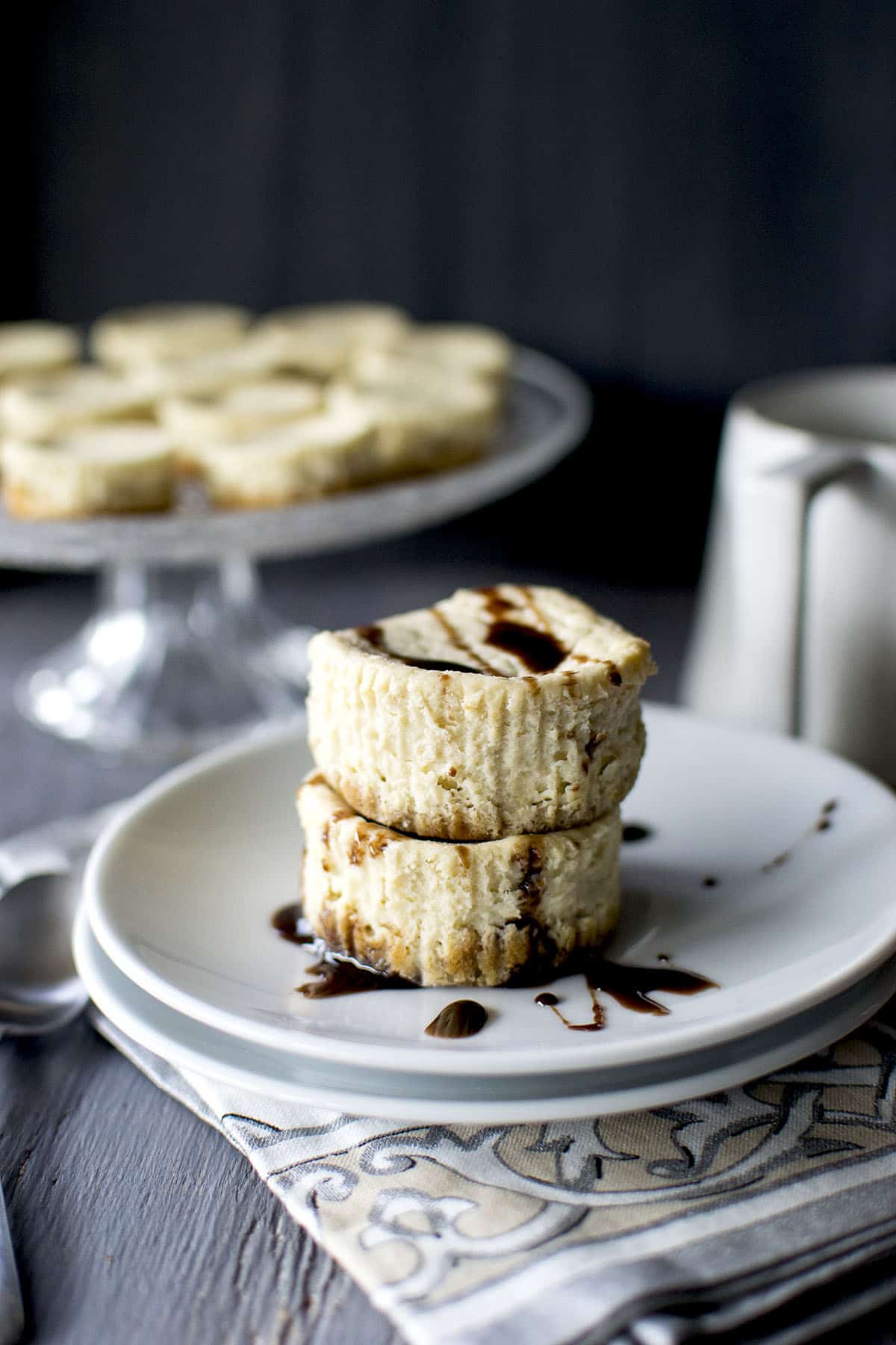 Stack of mini cheesecakes with chocolate drizzle