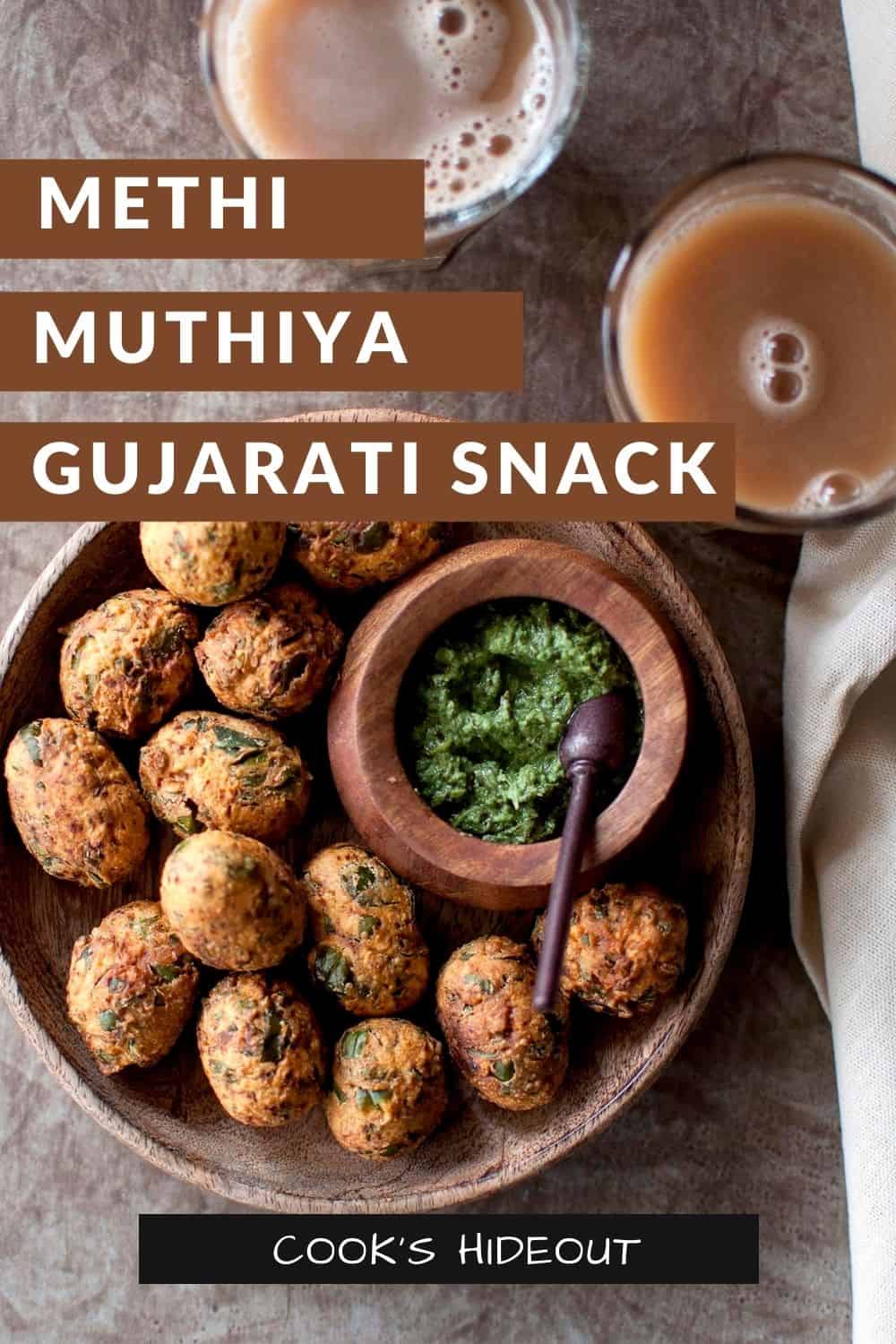 Wooden bowl with fried methi dumplings and a bowl of green chutney