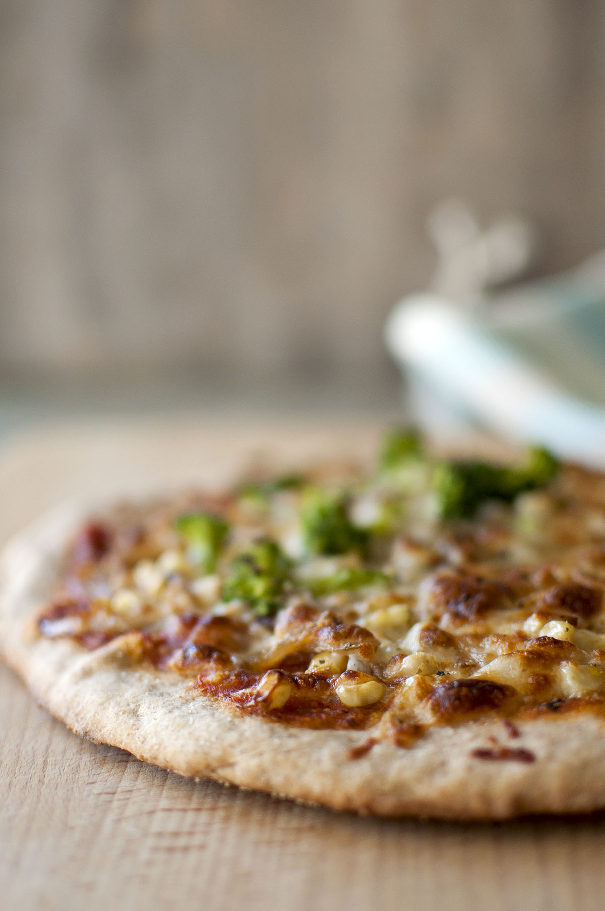 Thin crispy pizza with tomato sauce, cheese, corn, broccoli