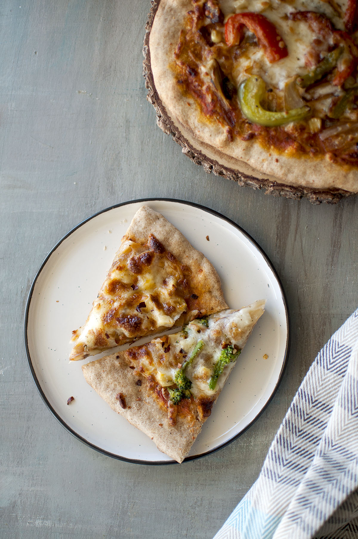 White plate with 2 slices of thin crust pizza 