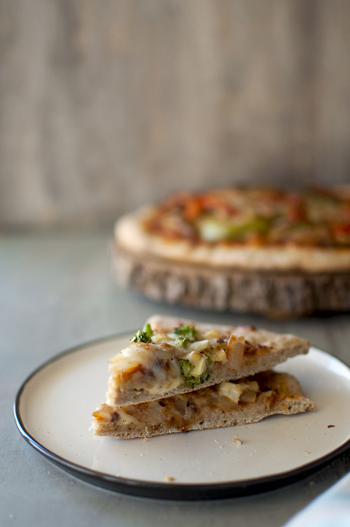 Grey plate with 2 pizza slices