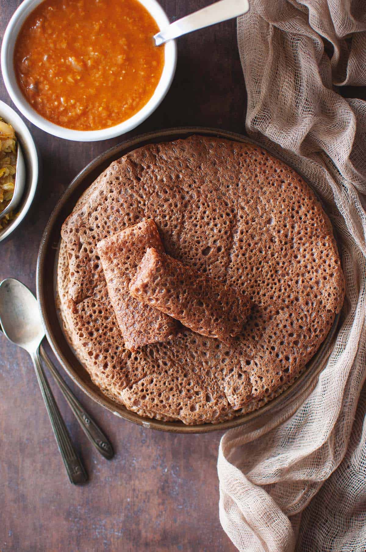 Top view of a plate with Quick Injera topped with 2 halves.