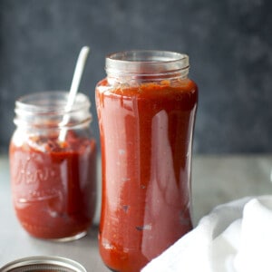 glass jars with vibrant red tomato achar