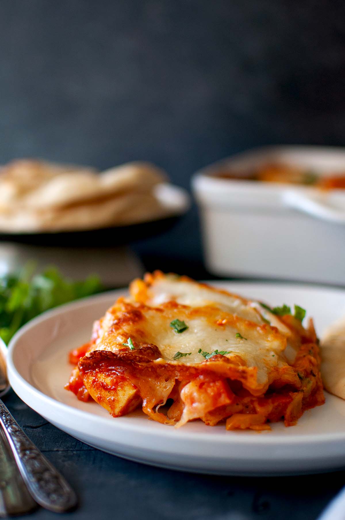 White plate with a slice of veggie lasagne