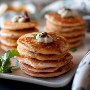 White plate with stacks of mini vegetable uthappam.