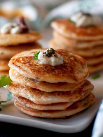 White plate with stacks of mini vegetable uthappam.