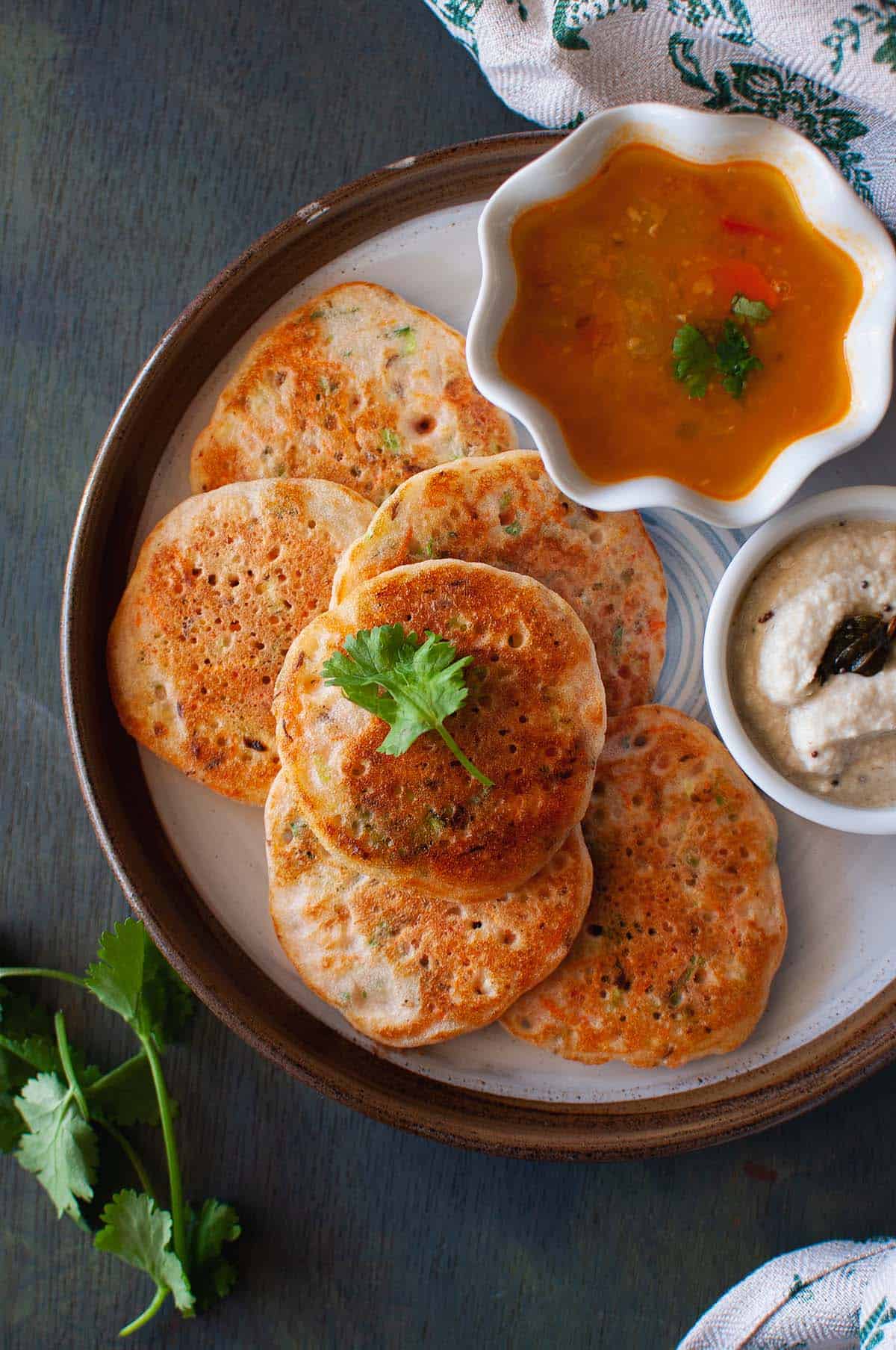Brown plate with mini vegetable uthappam.