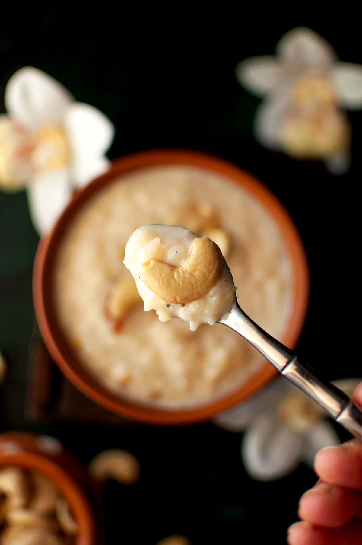 Spoon with paramannam topped with cashew.