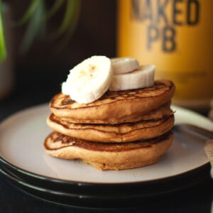 White plate with a stack of peanut butter pancakes.